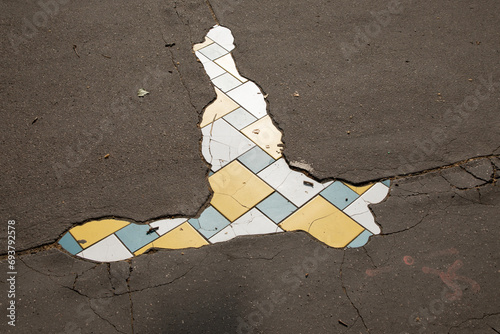 street hole in the sidewalk of the city repaired by an artist with tiling mosaic street art from Lyon city in France