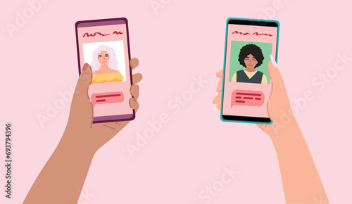 Hands holding mobile phones with open pages of online dating application on pink background