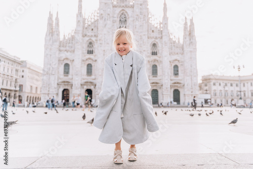 Fashionable little girl in an adult jacket on Duomo Square © Cavan