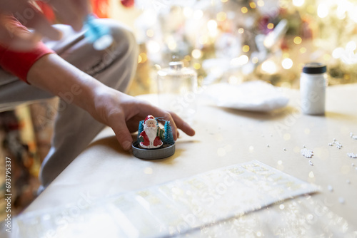 Close up of child making holiday decoration crafts photo