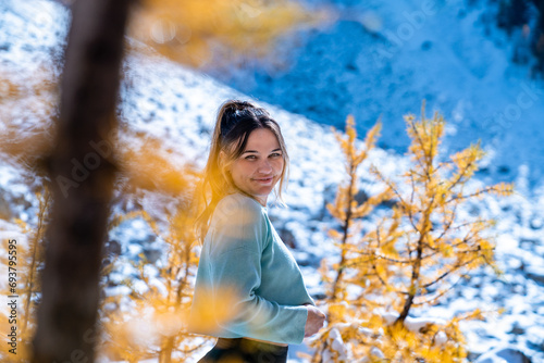 Girl Smiling Beside Golden Larches During Hike photo