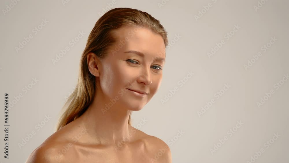 A beautiful girl with golden skin slightly smiles at the camera, showcasing her beauty. Slow motion.. High quality 4k footage A beautiful girl with golden skin slightly smiles at the camera, showcasing her beauty. Slow motion.. High quality 4k footage