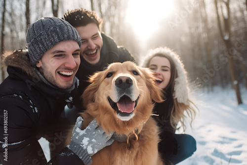 Close-Up Front View of a Happy Family Walking Their Pet Golden Retriever in the Winter Forest Outdoors – The Joyful Dog Leads the Way with a Protruded Tongue Winter Stroll Bliss