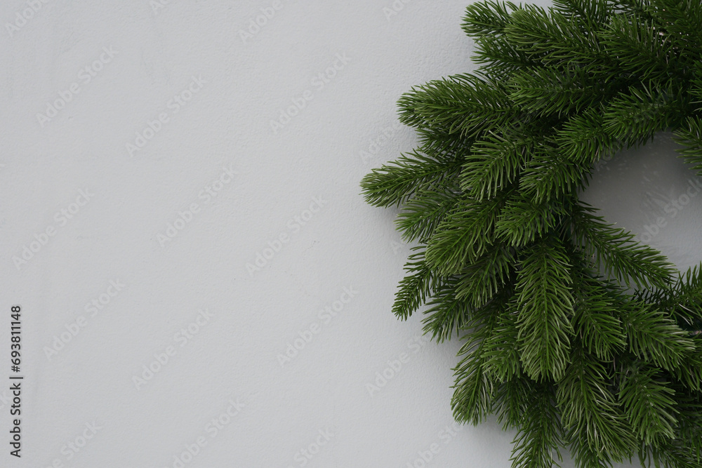 Christmas pruce wreath on a green wall - Christmas home interior.
