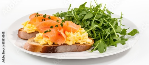Smoked salmon and scrambled egg on toast with salad. photo