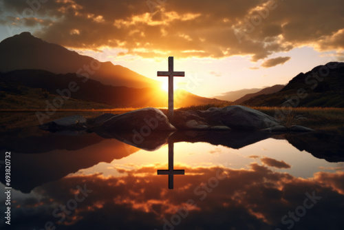 A cross reflects on water with the sunrise over mountains, symbolizing hope and spirituality.