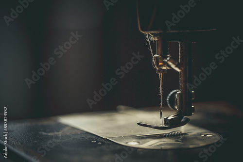 Vintage sewing machine, man sews on a vintage sewing machine, retro sewing machine