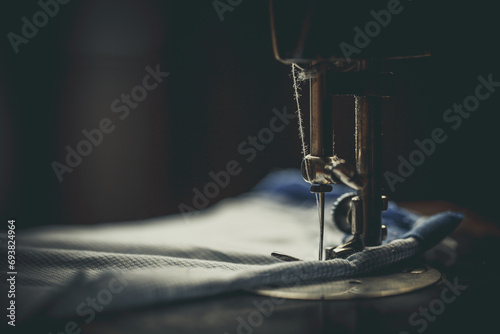 Vintage sewing machine, man sews on a vintage sewing machine, retro sewing machine photo
