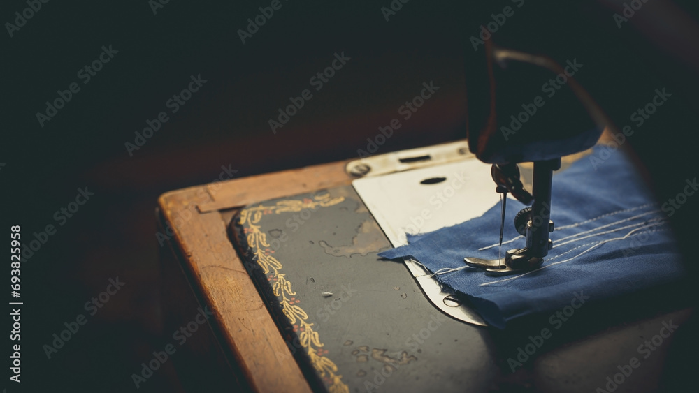 Vintage sewing machine, man sews on a vintage sewing machine, retro