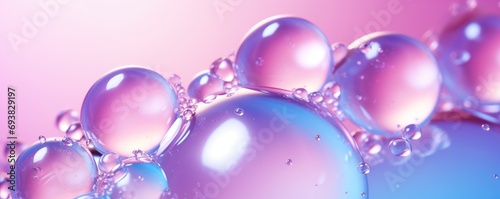 Serum or water drops on purple gradient surface background. Toner or cleanser lotion, hyaluronic serum. Clear liquid skin care cosmetic product texture with bubbles photo
