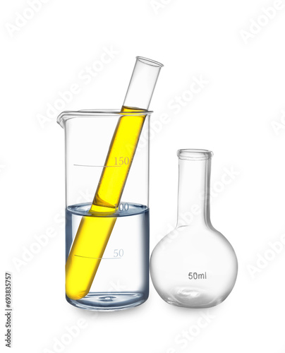 Glass flask, beaker and test tube with yellow liquid isolated on white
