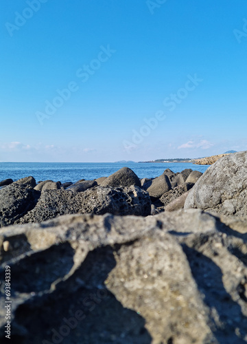Jeju sea with blue sky and basalt rocks. © binimin