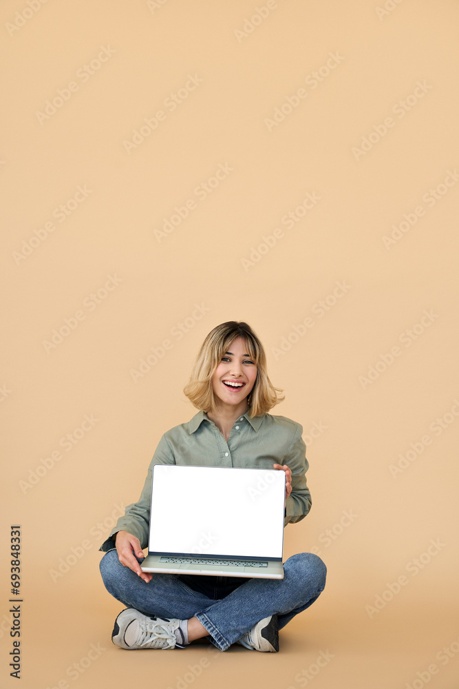 Happy gen z blonde young woman with laptop, smiling student girl holding computer on lap showing white mockup screen advertising elearning online website sitting isolated on background, vertical. Happy gen z blonde young woman with laptop, smiling student girl holding computer on lap showing white mockup screen advertising elearning online website sitting isolated on background, vertical.