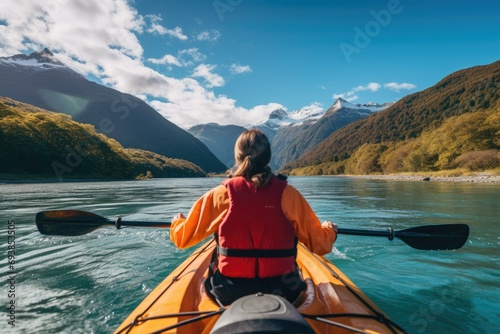 Woman in kayak floating on river.
