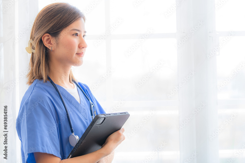 Asian Female medical assistant with smart tablet in white background. Portrait of mature female nurse working in hospital. Woman healthcare worker. Portrait of a good looking young nurse. Asian Female medical assistant with smart tablet in white background. Portrait of mature female nurse working in hospital. Woman healthcare worker. Portrait of a good looking young nurse.