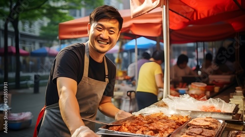 Street food vendor happily serving barbecue at a food stall photo