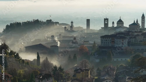 Bergamo, Italy. Amazing aerial landscape of the fog rises from the plains and covers the old town during sunrise. Bergamo one of the most beautiful city in Italy