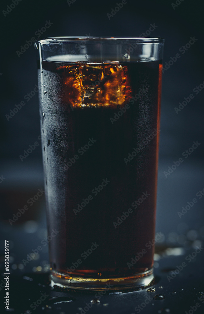 Soda pop with ice in a glass on a white background, delicious drink with ice, cola with ice - obrazy, fototapety, plakaty 