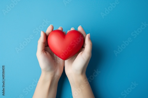 red heart held by hands as a symbol of love