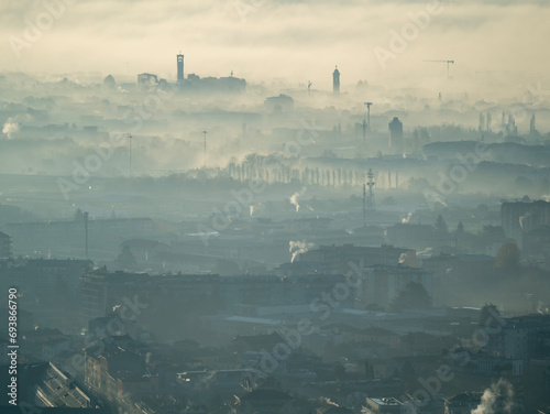 Bergamo, Italy. Amazing aerial landscape of the new town and flat land covered by the humidity and pollution. Fall season. Morning time