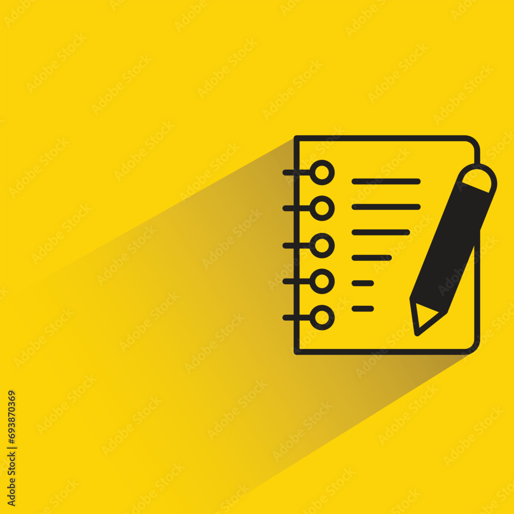 note paper and pen with shadow on yellow background note paper and pen with shadow on yellow background