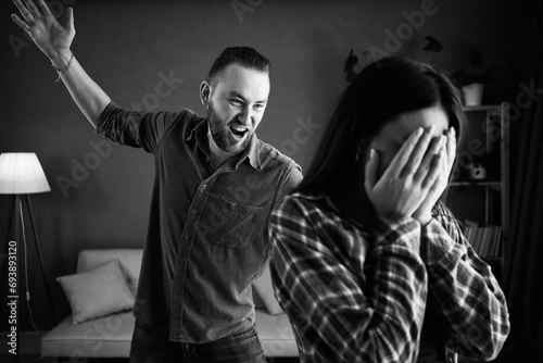 Home violence problems concept. Young couple shouting and blaming each other for problems