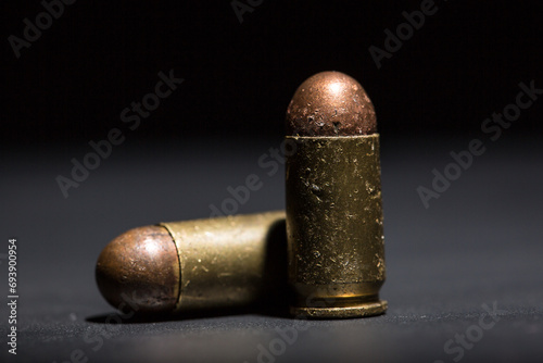 Firearm bullets on a black background, 9mm pistol cartridge