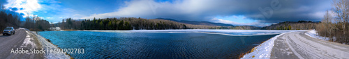 Green Mountain National Forest Backcountry Outdoor Recreation area in the snow with ponds, trees, and trails in Vermont. Tranquil road trip panorama of New England of the northeastern USA