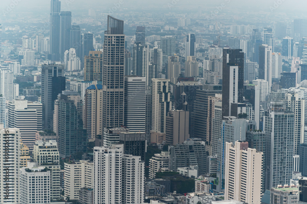Obraz premium Bangkok cityscapes, skyline, high rise office buildings and skyscrapers in Bangkok city, winter daylight, top view behind pollution haze or PM 2.5 in winter season, Bangkok, Thailand