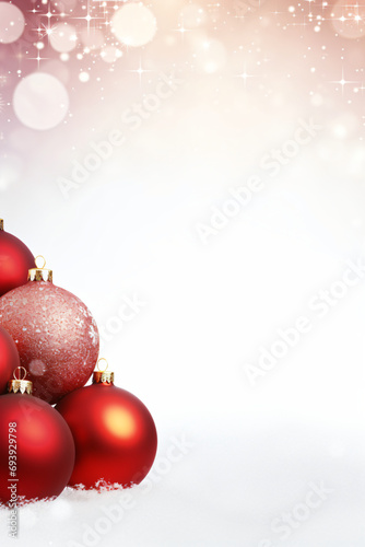 Red christmas baubles on snow with bokeh background