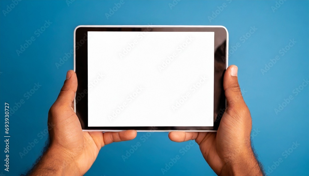 Hands holding white screen tablet, isolated on blue background Hands holding white screen tablet, isolated on blue background