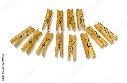 Wooden clothespin on white background with shadow reflection below. photo