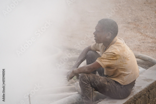 Bore Well Drilling in Progress with a Dedicated Helper Collaboration and Dust in indian street stock images, hard worker, indian labors 