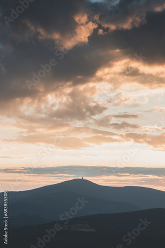 Dramatic sunset with rainy clouds over Lysa Hora peak Beskydy mountains  Czech Republic