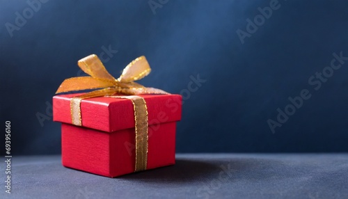 Red gift box and blue background, text space, christmas concept 