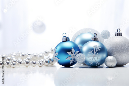 Christmas baubles with silver and blue sparkles on a white background
