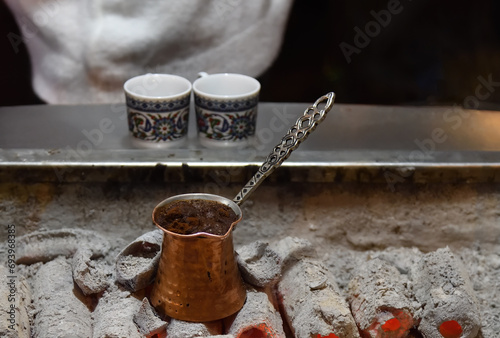 Ember Turkish coffee. Roasted Turkish coffee. Traditional nubian coffee making. Coffee turk on the coal. photo