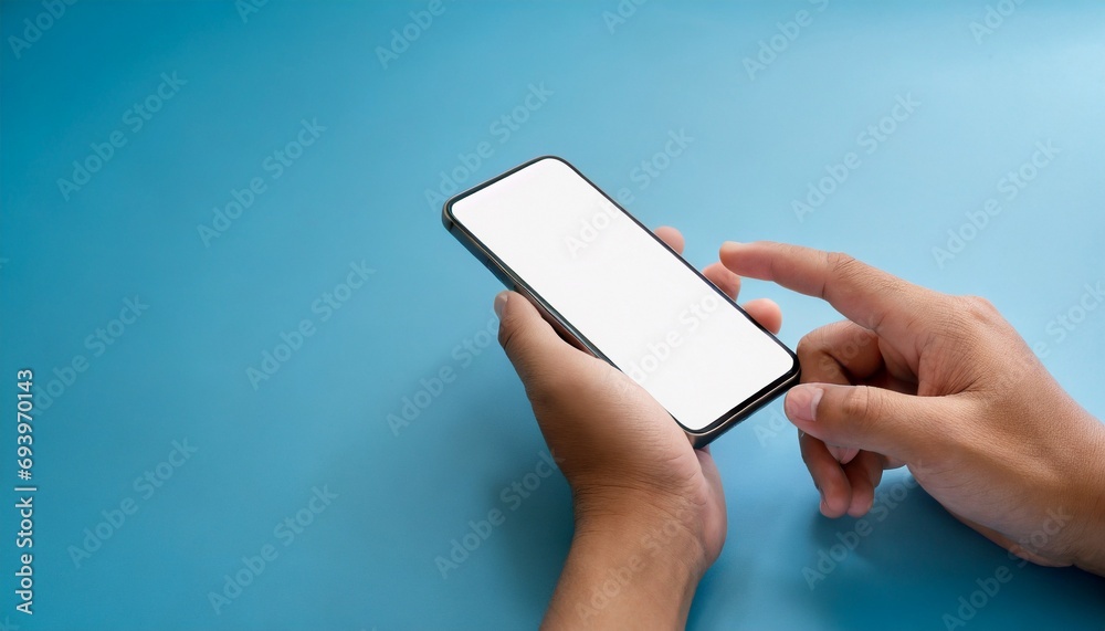 Hand using smartphone with blank screen, isolated on blue background, text space Hand using smartphone with blank screen, isolated on blue background, text space