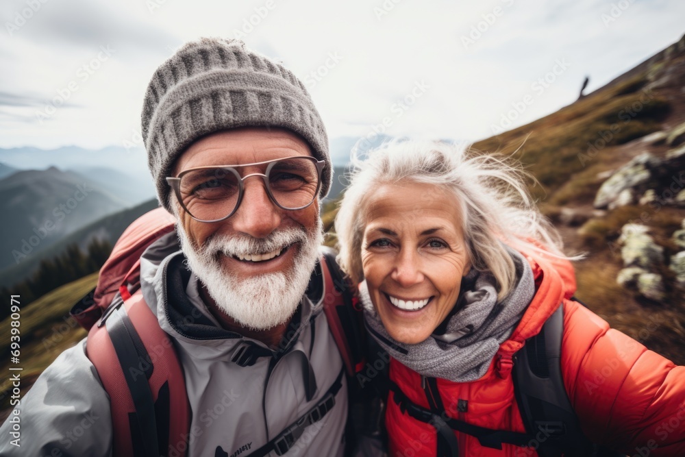 Smiling senior couple taking selfie in nature