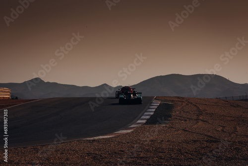 Sport racing prototype go fast at the race track fast during sunset