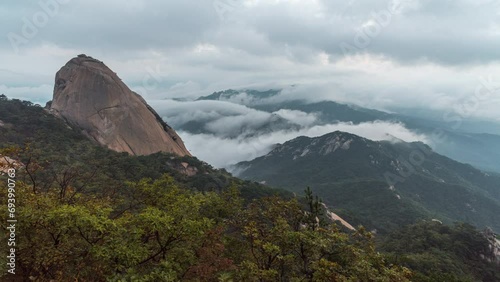 Time Lapse 4k, morning mist cover seoul during sunrise View of the top of Bukhansan Mountain, South Korea