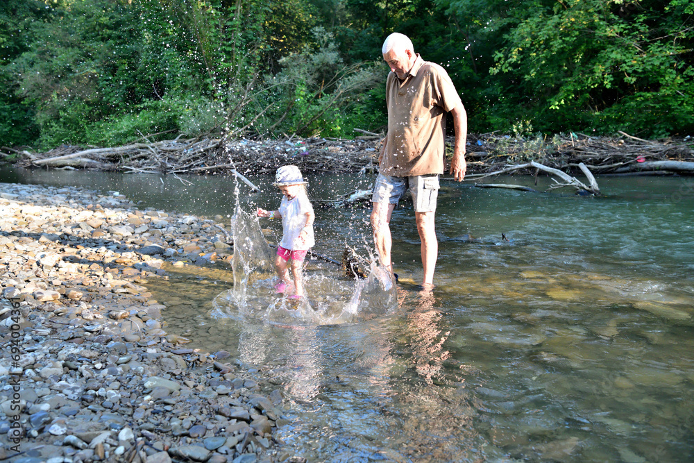 Slashing river water after throwing a stone into the water
