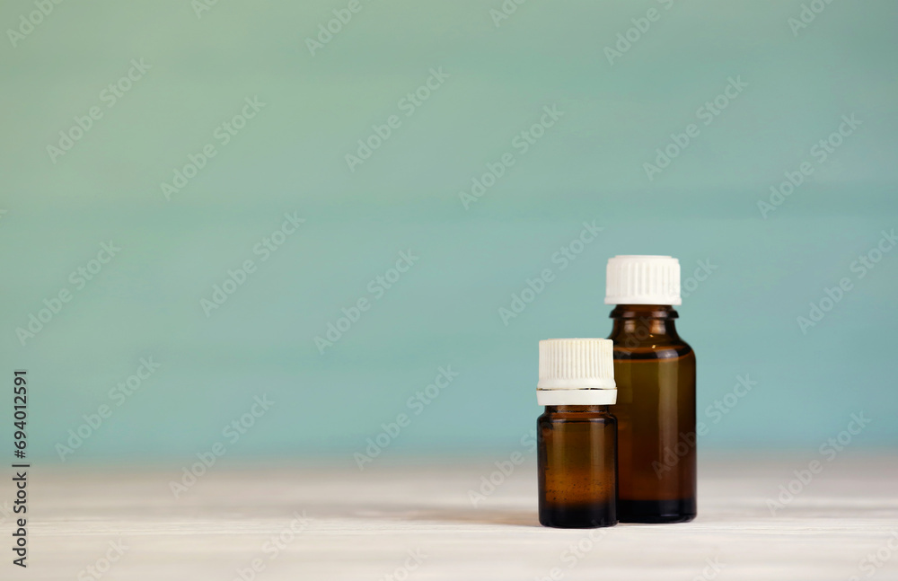 Two natural oils for beauty care. Nail and cuticle oil and body oil in glass bottle Two natural oils for beauty care. Nail and cuticle oil and body oil in glass bottle