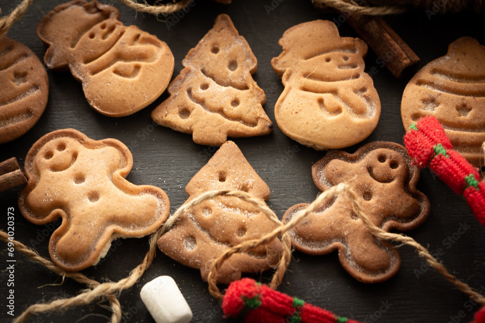 Christmas cookies, decorations on dark background. Close-up. Christmas and New Year traditions concept