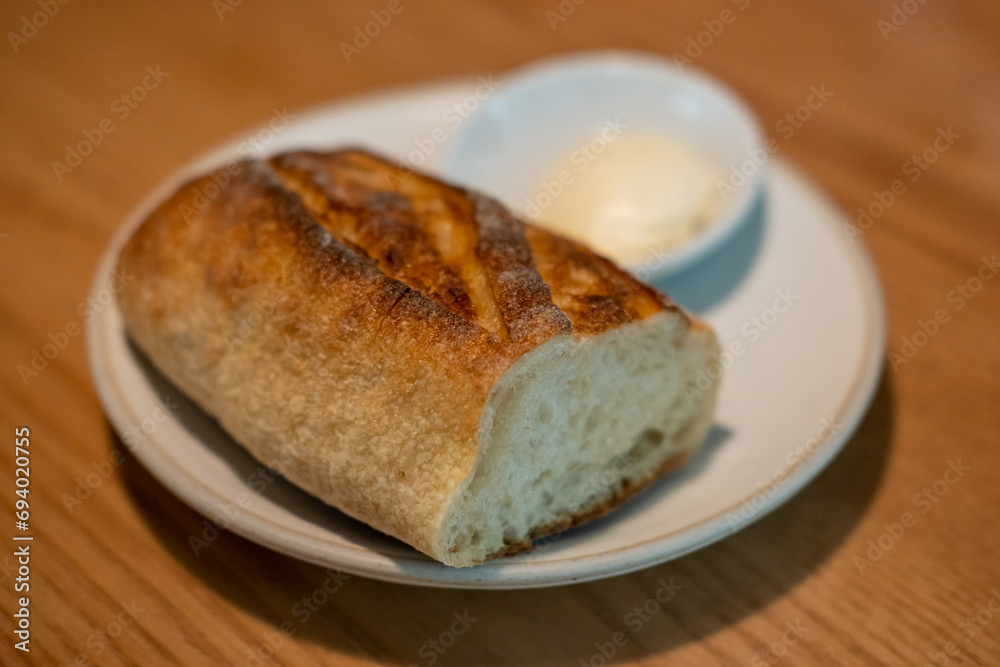 Bread with butter served on plate, on the table in the restaurant Bread with butter served on plate, on the table in the restaurant