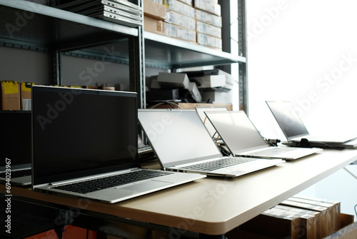 Obraz na plátně Row of laptops being prepared and set up for new employees in a company