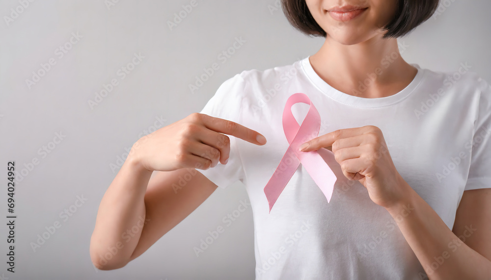 Woman Supporting Breast Cancer Awareness with Pink Ribbon