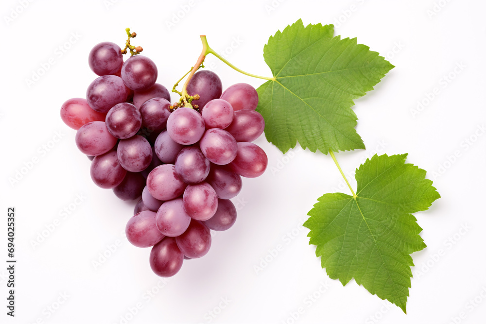 Fototapeta premium Isolated top-view of halved red grapes with verdant foliage on a white backdrop.