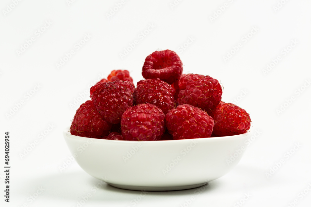 Fresh red raspberries on a white background, raspberries for dessert Fresh red raspberries on a white background, raspberries for dessert