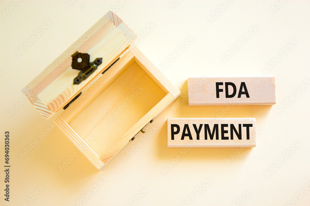 FDA Food and Drug Administration payment symbol. Concept words FDA payment on beautiful wooden blocks. Beautiful white table background. Empty wooden chest. Business FDA payment concept. Copy space.